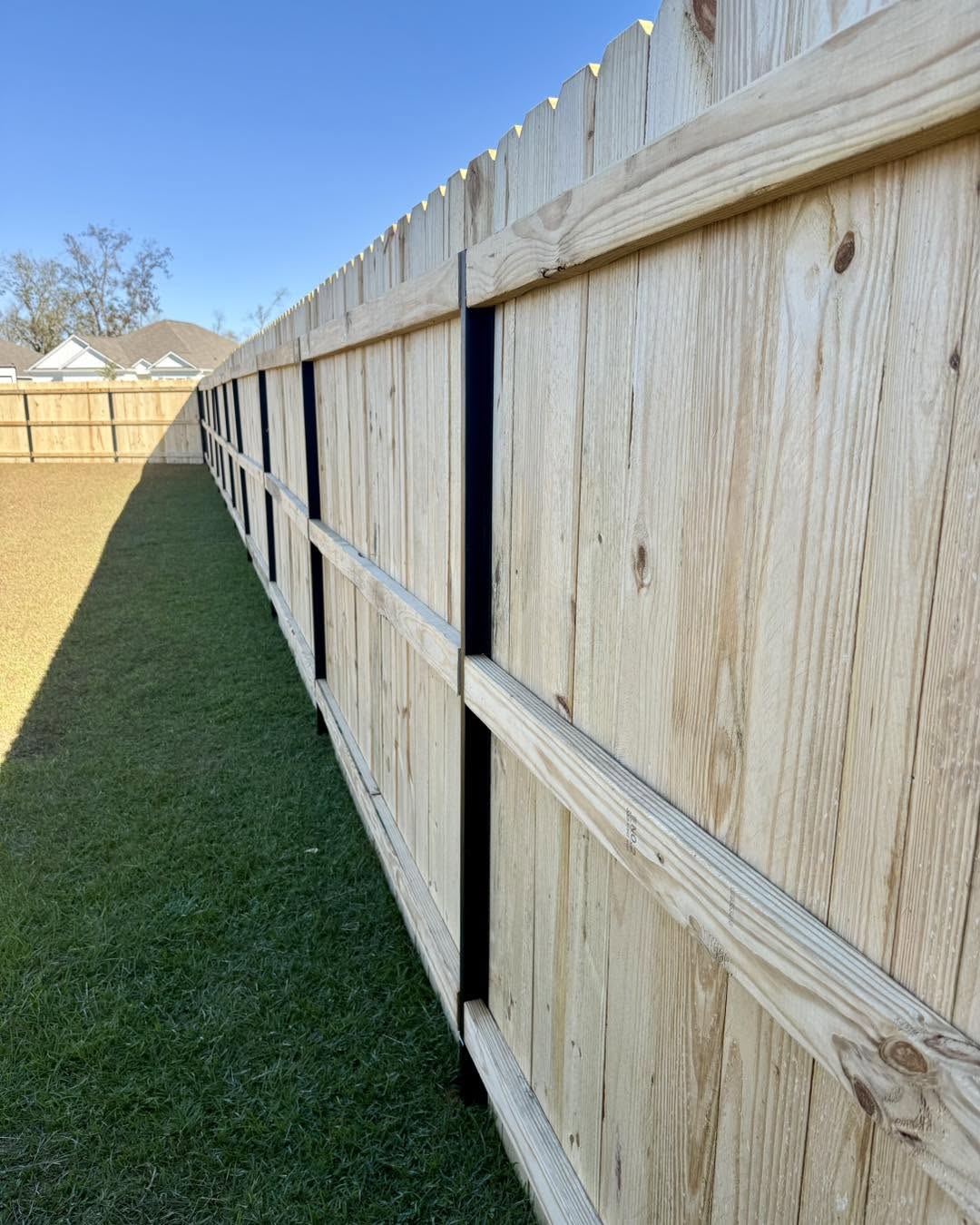 Wood privacy fence on steel posts